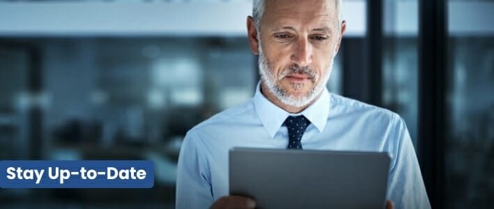White Haired Bearded Man Holding A Tablet